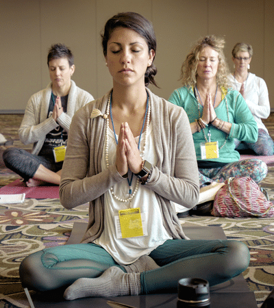 Students in prayer palms to heart pose