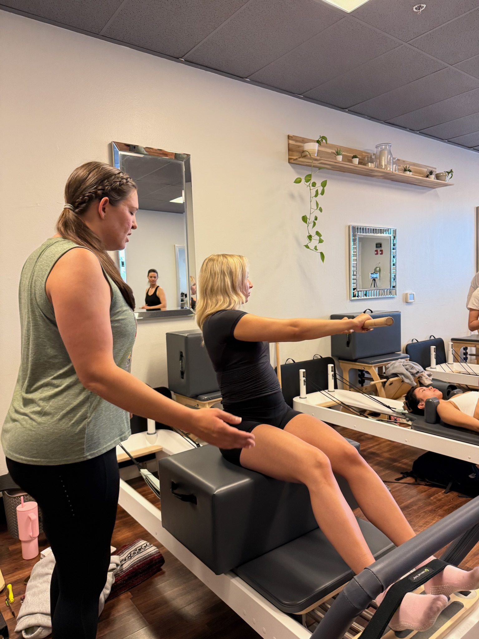 Pilates Teacher Training students practicing short box series on the reformer while another student teaches