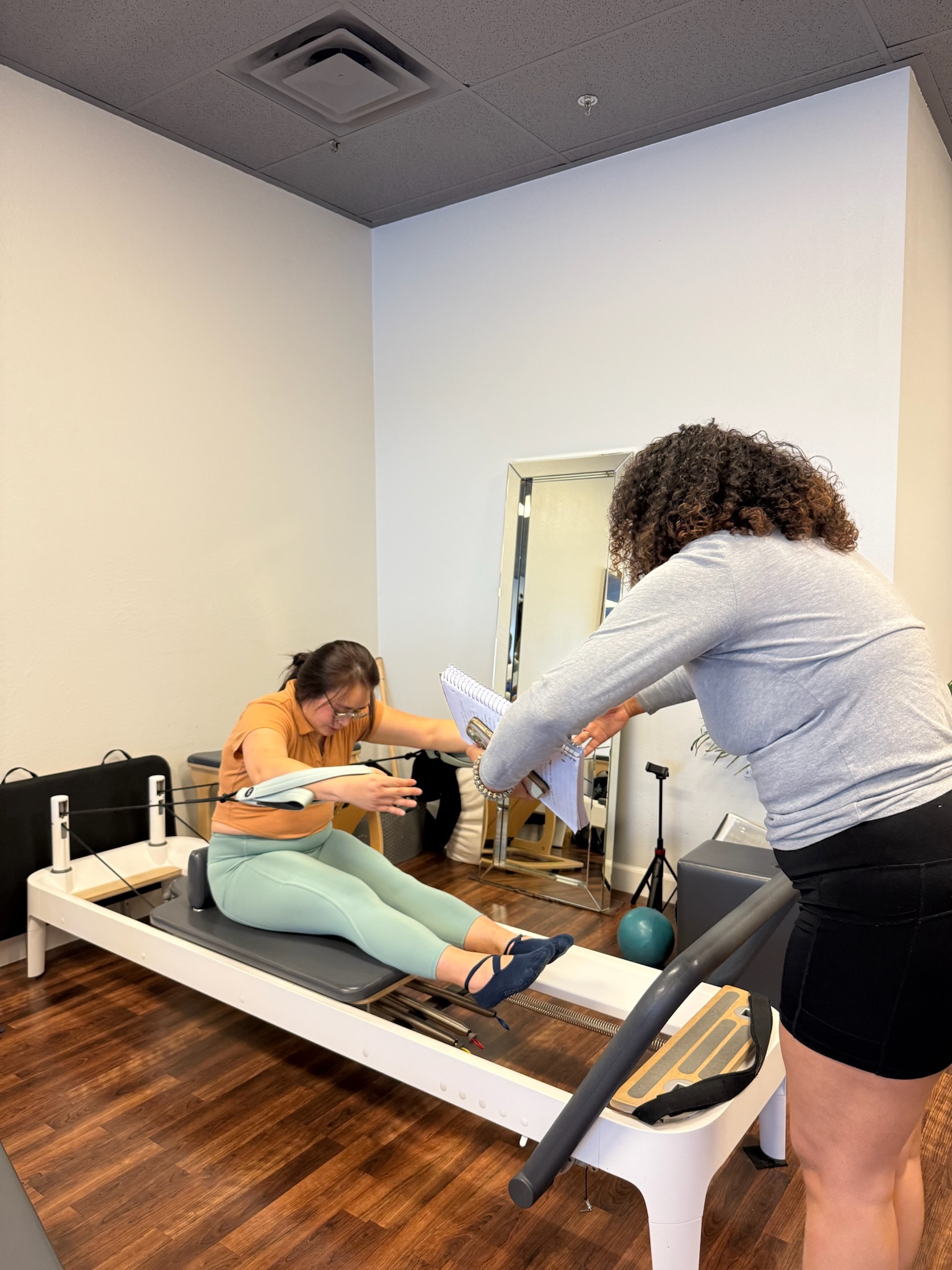 IMG_2535 Pilates Teacher Training students practicing seated arm series on the reformer