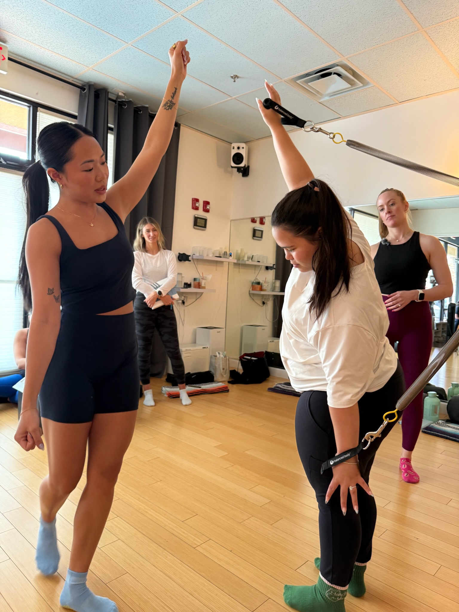 Pilates Teacher Training students practicing arm series on the cadillac/trapeze table