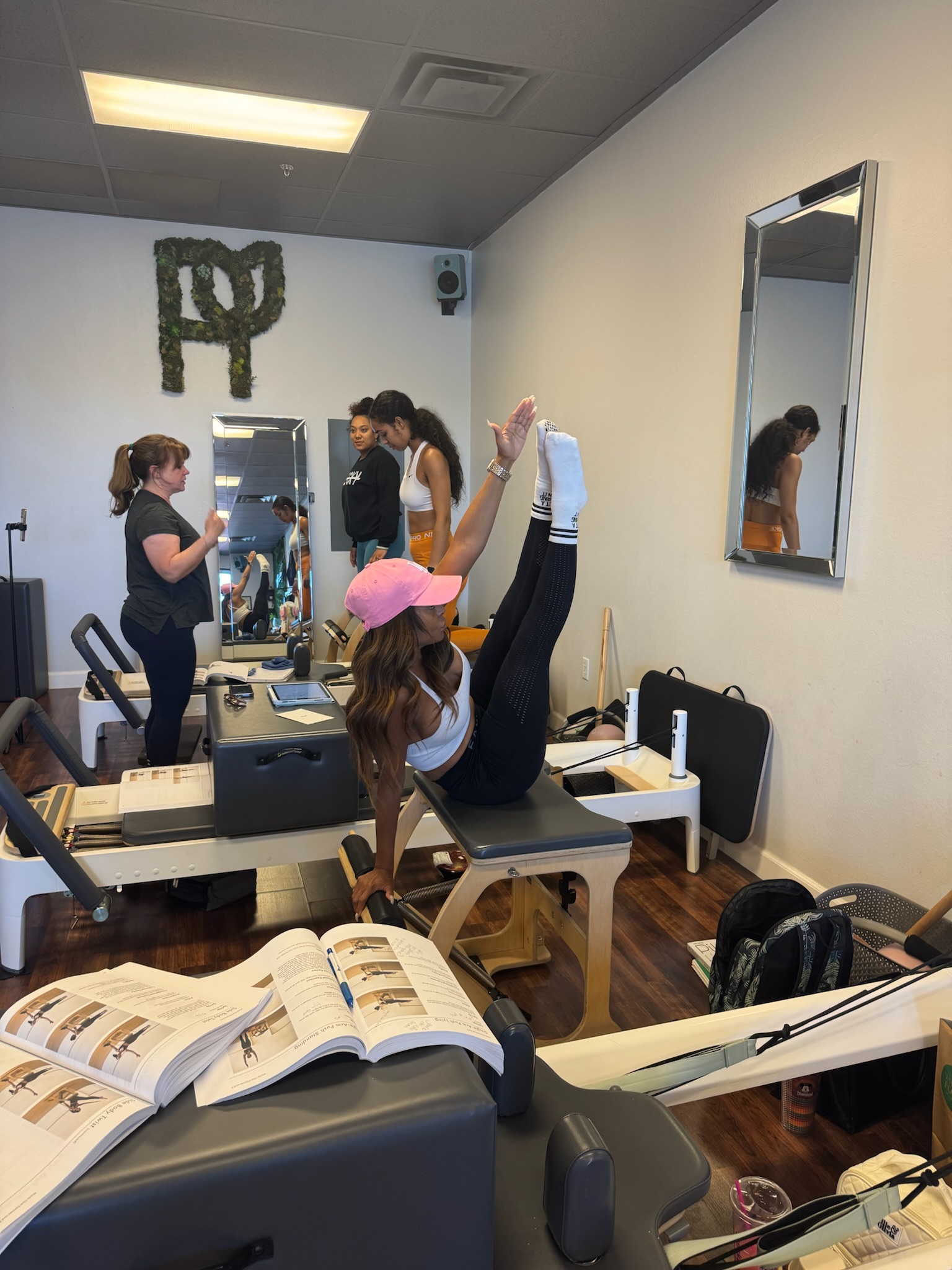 Pilates Teacher Training students practicing teaser on the wunda chair